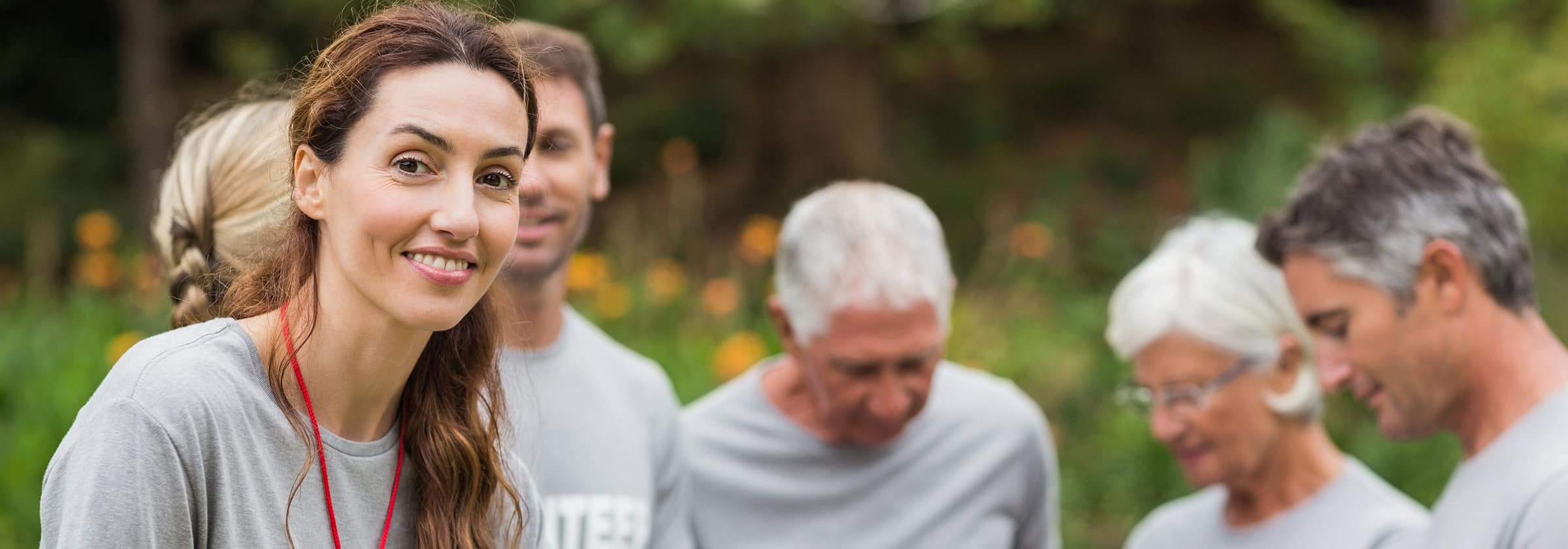 A group of men and women volunteering at a senior living facility