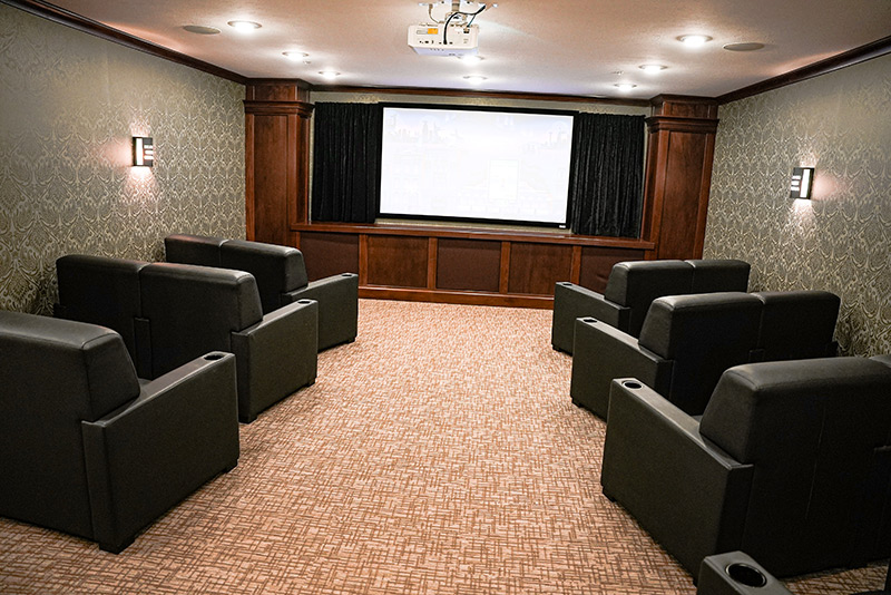 Movie theater room with comfortable leather chairs at Mission Grove at Stoneybrook